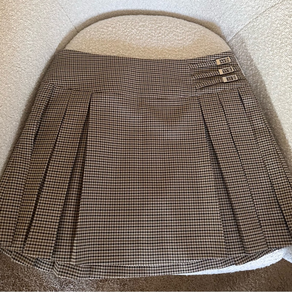 Meshki Pleated Buckle Mini Skirt